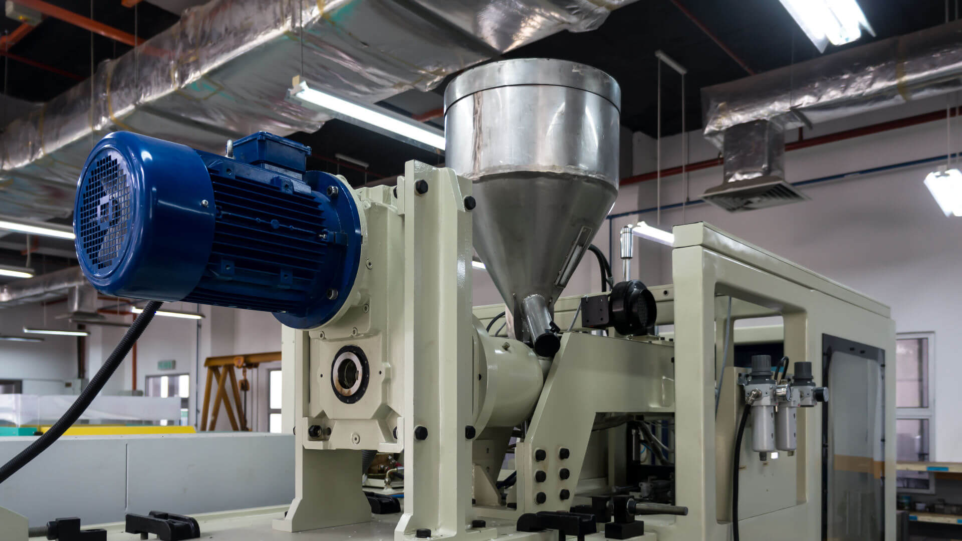 Close up of a Plastic Injection Molding machine that is using a TRanscyko brand Speed reducer and gearbox to control movement